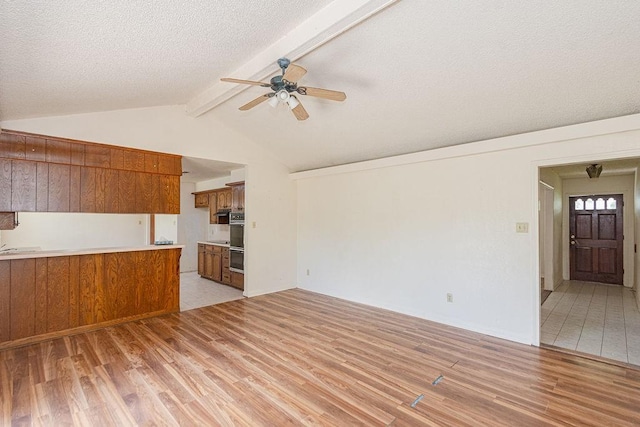 8111 Dellanera Dr, Hitchcock, TX 77563 - unfurnished living room featuring light wood-style floors, a ceiling fan, and a textured ceiling