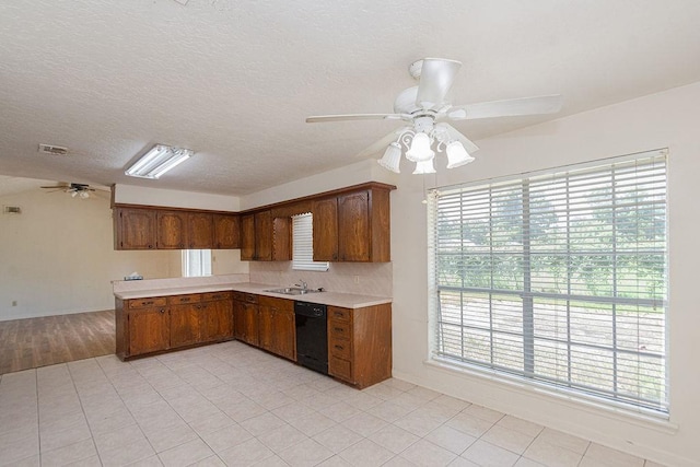 8111 Dellanera Dr, Hitchcock, TX 77563 - kitchen with a ceiling fan, dishwasher, light countertops, brown cabinets, and a peninsula
