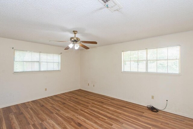 8111 Dellanera Dr, Hitchcock, TX 77563 - unfurnished room featuring wood finished floors, ceiling fan, and a textured ceiling