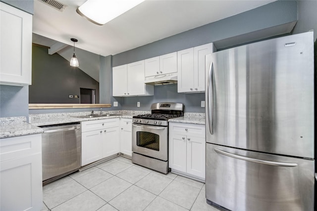 2710 Magnolia Ct, Stafford, TX 77477 - kitchen with appliances with stainless steel finishes, under cabinet range hood, white cabinetry, and light tile patterned floors