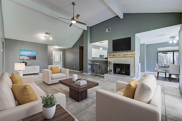 2710 Magnolia Ct, Stafford, TX 77477 - living area with ceiling fan, beam ceiling, high vaulted ceiling, and a tiled fireplace