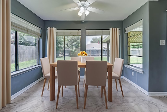 2710 Magnolia Ct, Stafford, TX 77477 - dining area with marble finish flooring, healthy amount of natural light, and a ceiling fan