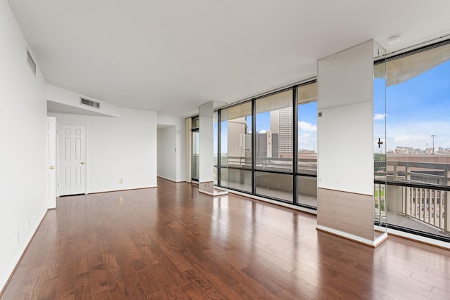 15 Greenway Plz Unit 10G, Houston, TX 77046 - unfurnished room featuring floor to ceiling windows, wood finished floors, and a smoke detector
