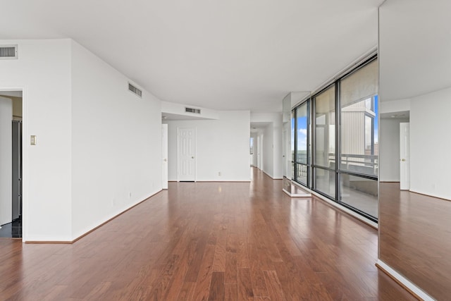 15 Greenway Plz Unit 10G, Houston, TX 77046 - empty room with floor to ceiling windows and wood finished floors