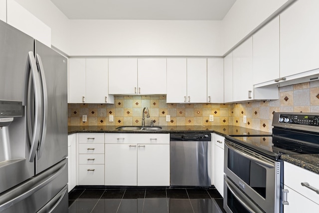 15 Greenway Plz Unit 10G, Houston, TX 77046 - kitchen featuring stainless steel appliances, white cabinets, tasteful backsplash, dark tile patterned flooring, and dark stone counters