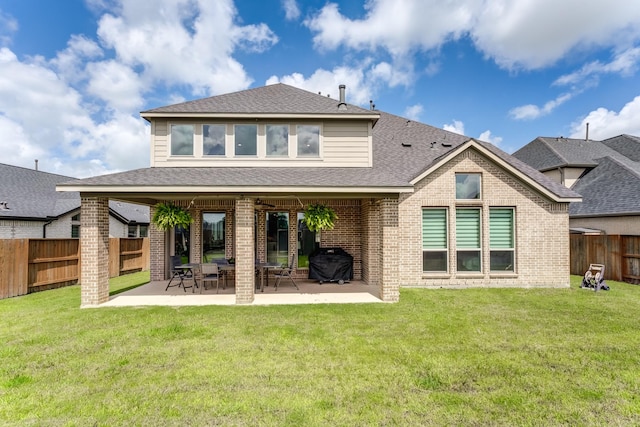 6907 Pondhawk Dr, Katy, TX 77493 - back of property featuring a fenced backyard, brick siding, a patio, and roof with shingles