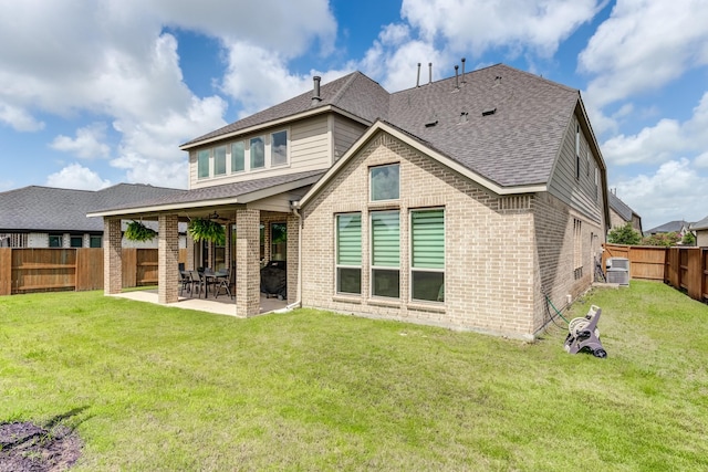 6907 Pondhawk Dr, Katy, TX 77493 - back of house with brick siding, roof with shingles, a fenced backyard, and a patio
