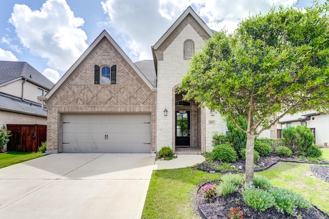 6907 Pondhawk Dr, Katy, TX 77493 - french country style house featuring brick siding, driveway, a garage, and stone siding