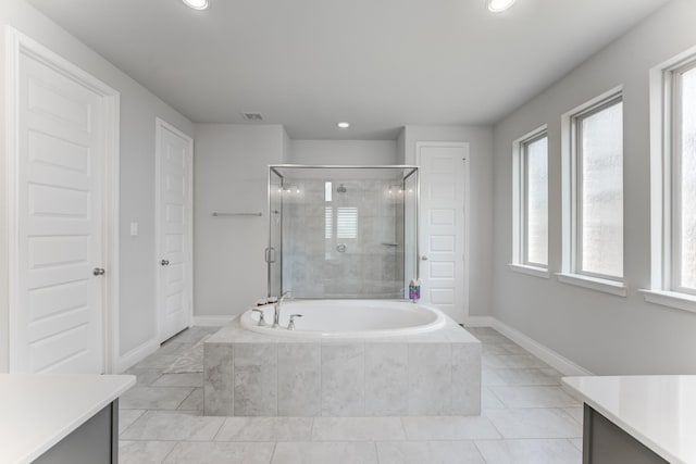 6907 Pondhawk Dr, Katy, TX 77493 - bathroom with vanity, a bath, healthy amount of natural light, a shower stall, and recessed lighting