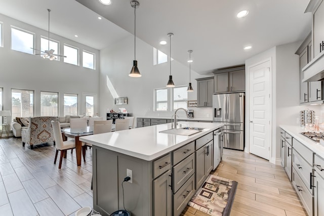 6907 Pondhawk Dr, Katy, TX 77493 - kitchen featuring stainless steel appliances, gray cabinets, light countertops, ceiling fan, and recessed lighting