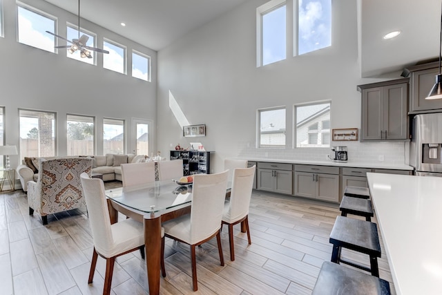 6907 Pondhawk Dr, Katy, TX 77493 - dining room featuring ceiling fan, a high ceiling, and recessed lighting