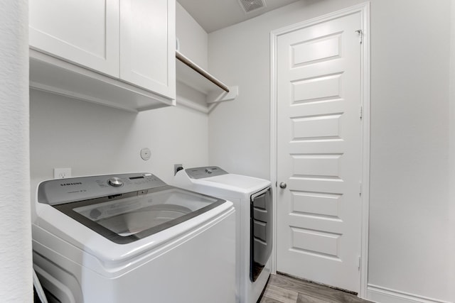 6907 Pondhawk Dr, Katy, TX 77493 - washroom with cabinet space, independent washer and dryer, and light wood-style flooring