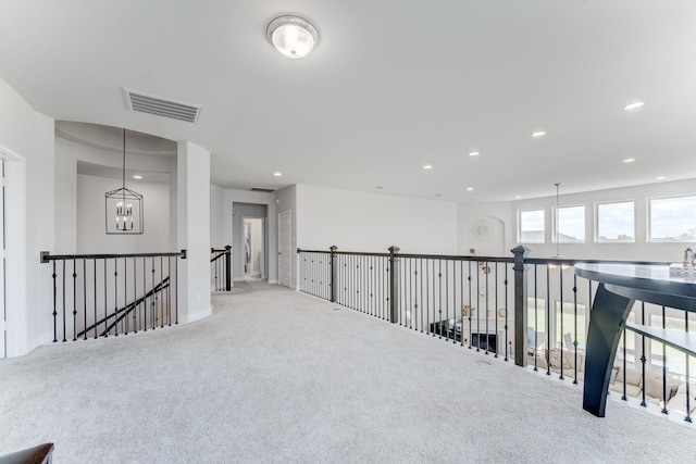 6907 Pondhawk Dr, Katy, TX 77493 - corridor featuring an upstairs landing, carpet floors, recessed lighting, and a chandelier