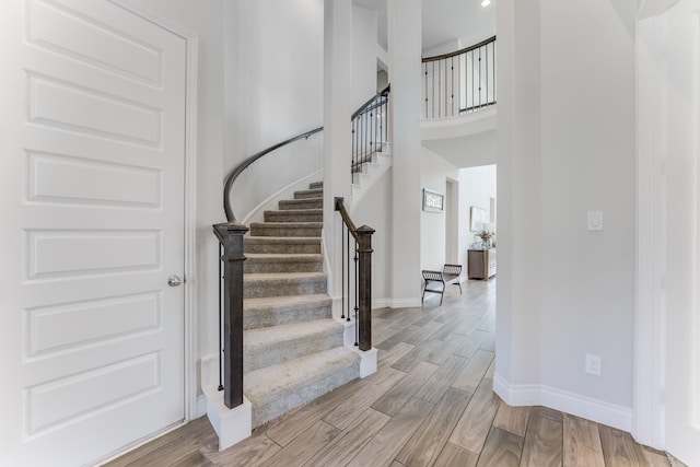 6907 Pondhawk Dr, Katy, TX 77493 - stairway featuring wood finished floors and a towering ceiling
