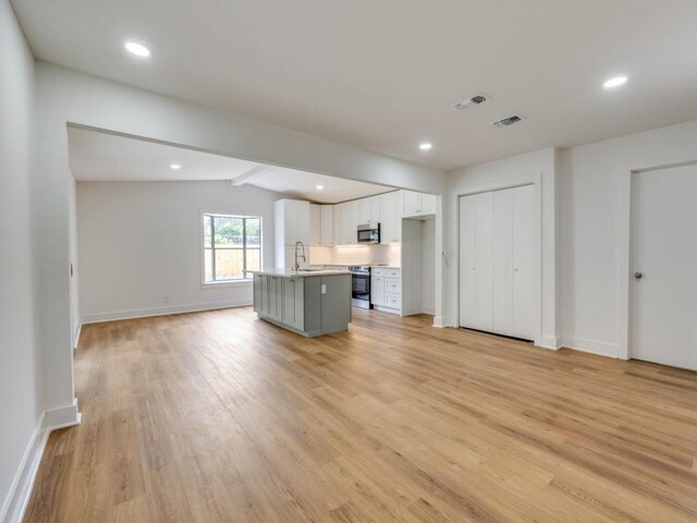 527 Blakeley Dr, San Antonio, TX 78209 - unfurnished living room with light wood-style flooring and recessed lighting