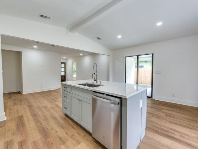 527 Blakeley Dr, San Antonio, TX 78209 - kitchen featuring dishwasher, gray cabinetry, light countertops, light wood-style flooring, and an island with sink
