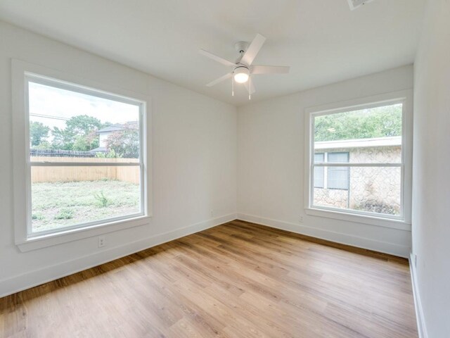 527 Blakeley Dr, San Antonio, TX 78209 - empty room with healthy amount of natural light, light wood-style flooring, and a ceiling fan