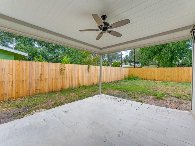 527 Blakeley Dr, San Antonio, TX 78209 - fenced backyard with ceiling fan and a patio area