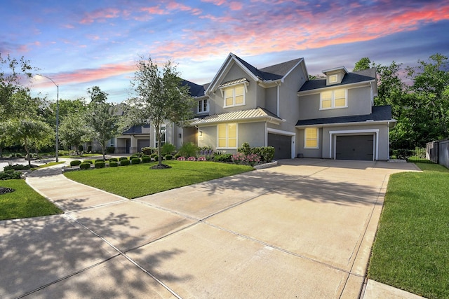 9411 Plaza Point Dr, Missouri City, TX 77459 - traditional-style house featuring stucco siding, an attached garage, driveway, a standing seam roof, and a front lawn