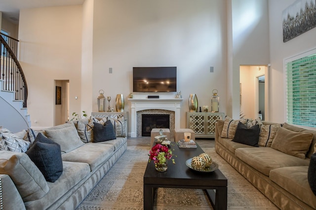 9411 Plaza Point Dr, Missouri City, TX 77459 - living area with a high ceiling, stairs, and a fireplace