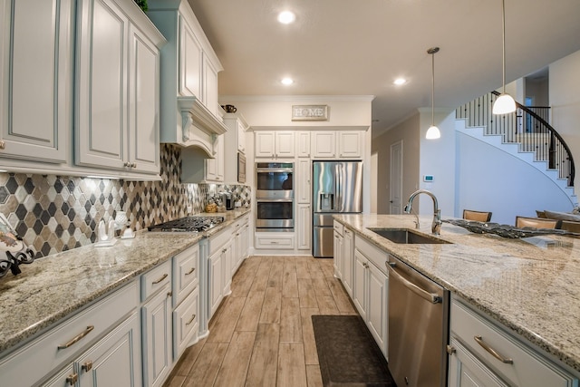 9411 Plaza Point Dr, Missouri City, TX 77459 - kitchen featuring appliances with stainless steel finishes, decorative backsplash, pendant lighting, light stone countertops, and ornamental molding