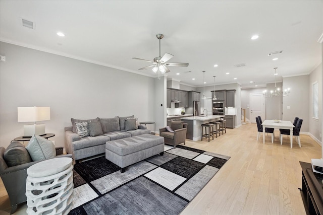 408 W Pierce St, Houston, TX 77019 - living room featuring light wood finished floors, ceiling fan, recessed lighting, crown molding, and a chandelier