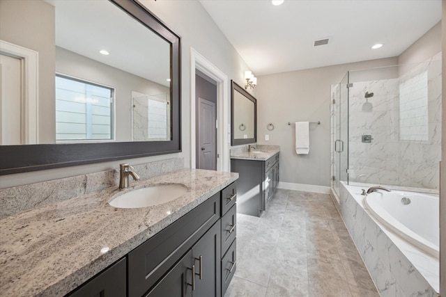 408 W Pierce St, Houston, TX 77019 - bathroom with a marble finish shower, a garden tub, two vanities, and recessed lighting
