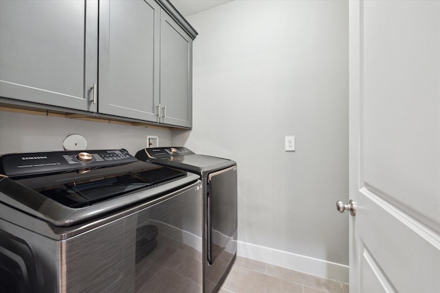 408 W Pierce St, Houston, TX 77019 - laundry area with washer and dryer, cabinet space, and light tile patterned floors