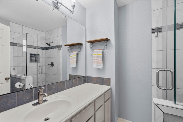 1011 Elm Pointe, League City, TX 77573 - full bathroom featuring a stall shower, vanity, and a textured wall