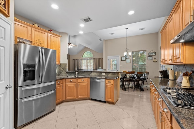 1011 Elm Pointe, League City, TX 77573 - kitchen featuring appliances with stainless steel finishes, wall chimney range hood, decorative backsplash, a peninsula, and lofted ceiling
