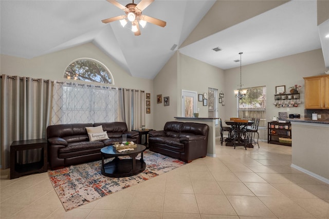1011 Elm Pointe, League City, TX 77573 - living room with light tile patterned flooring, ceiling fan, high vaulted ceiling, and a chandelier