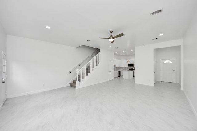 8159 Crestview Dr, Houston, TX 77028 - unfurnished living room featuring ceiling fan, stairway, recessed lighting, and light floors
