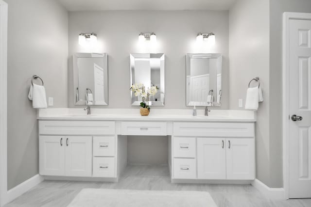 8159 Crestview Dr, Houston, TX 77028 - bathroom featuring double vanity and marble look tiles