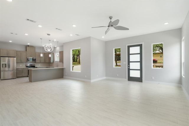 301 Knights Row, Horseshoe Bay, TX 78657 - unfurnished living room with recessed lighting, ceiling fan, light wood-style floors, and a chandelier