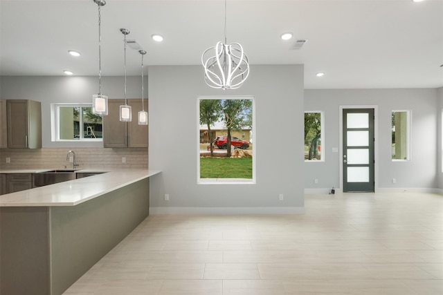 301 Knights Row, Horseshoe Bay, TX 78657 - kitchen with light countertops, plenty of natural light, tasteful backsplash, recessed lighting, and decorative light fixtures