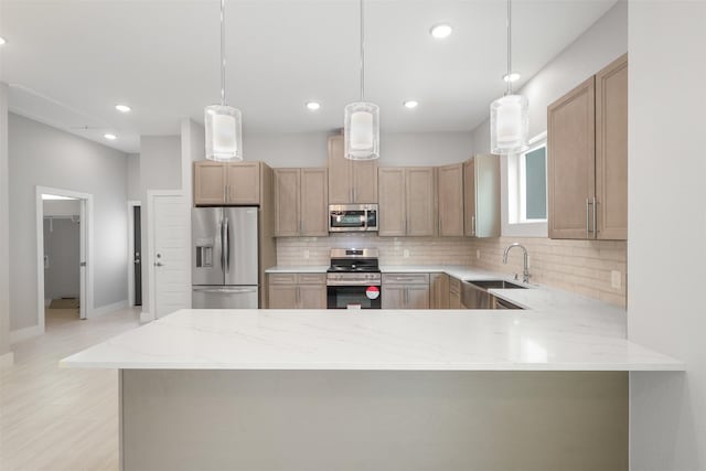 301 Knights Row, Horseshoe Bay, TX 78657 - kitchen featuring stainless steel appliances, tasteful backsplash, a peninsula, light stone counters, and recessed lighting