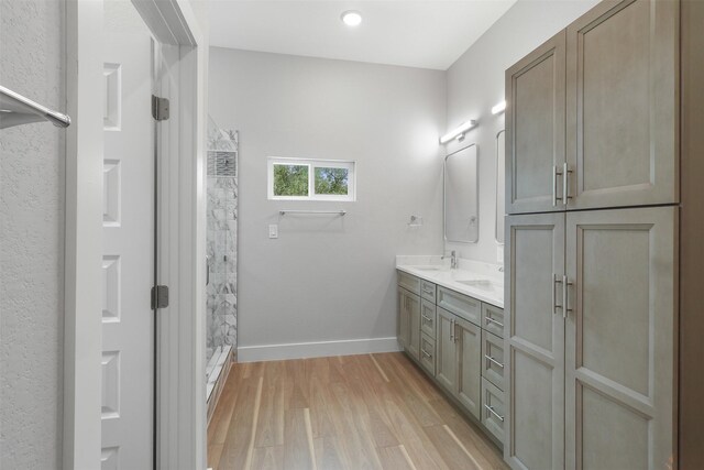301 Knights Row, Horseshoe Bay, TX 78657 - full bath featuring a shower stall, double vanity, and wood finished floors
