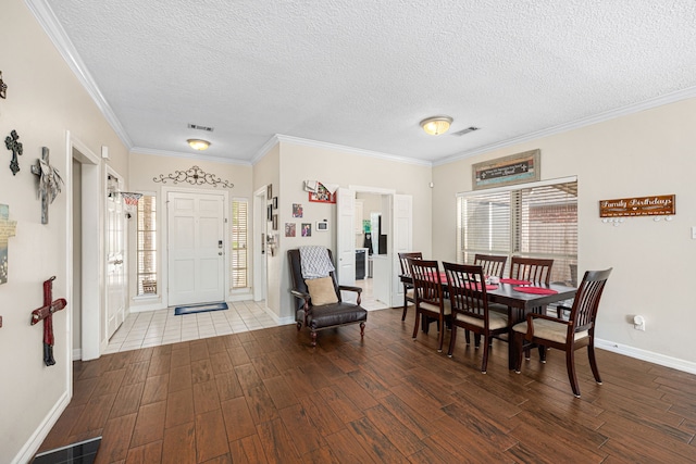 7202 N Fawn River Cir, Spring, TX 77379 - dining area with wood finished floors, a textured ceiling, and ornamental molding