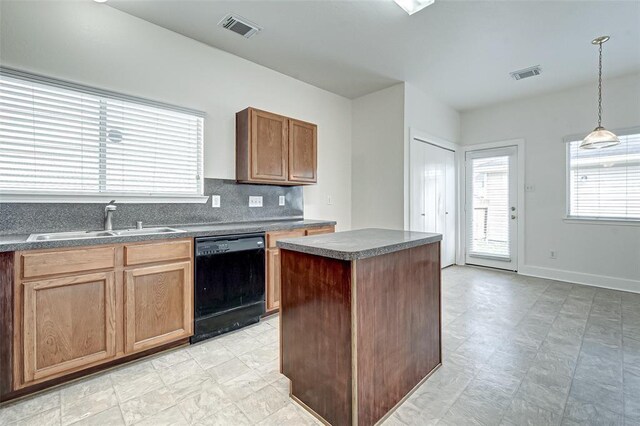 11920 Princess Garden Way, Houston, TX 77047 - kitchen with black dishwasher, dark countertops, decorative backsplash, pendant lighting, and a center island