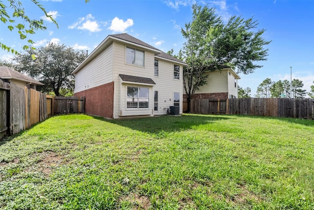 6810 Strathmore Place Ct, Katy, TX 77449 - back of house with brick siding, a fenced backyard, and roof with shingles