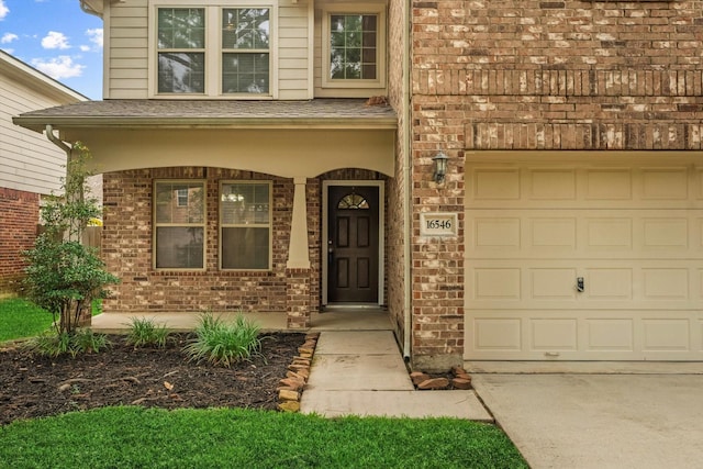 16546 Whitaker Creek Dr, Houston, TX 77095 - property entrance with brick siding, driveway, and a garage
