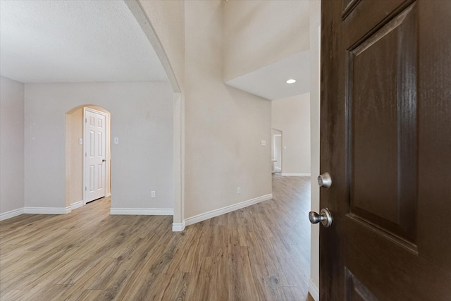 16546 Whitaker Creek Dr, Houston, TX 77095 - foyer with arched walkways and light wood finished floors