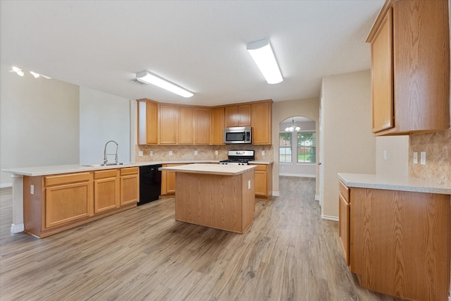 16546 Whitaker Creek Dr, Houston, TX 77095 - kitchen with appliances with stainless steel finishes, a peninsula, light wood-style flooring, and tasteful backsplash