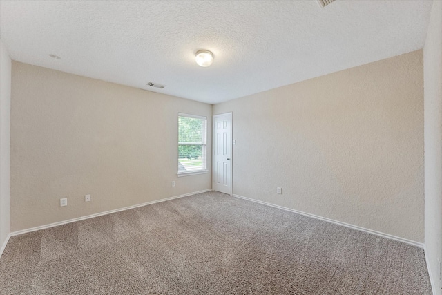 16546 Whitaker Creek Dr, Houston, TX 77095 - carpeted empty room with baseboards and a textured ceiling
