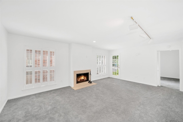 1601 S Shepherd Dr S Unit 215, Houston, TX 77019 - unfurnished living room with a fireplace with flush hearth, carpet flooring, and track lighting