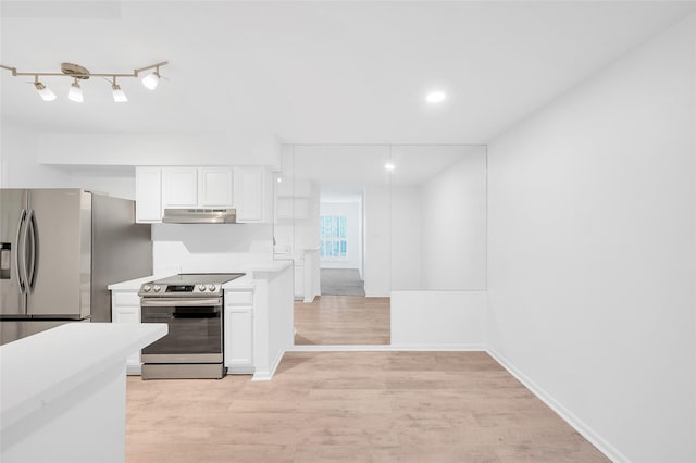 1601 S Shepherd Dr S Unit 215, Houston, TX 77019 - kitchen featuring appliances with stainless steel finishes, under cabinet range hood, light countertops, light wood-style floors, and white cabinetry