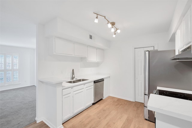 1601 S Shepherd Dr S Unit 215, Houston, TX 77019 - kitchen featuring stainless steel dishwasher, exhaust hood, light countertops, white cabinetry, and light wood finished floors