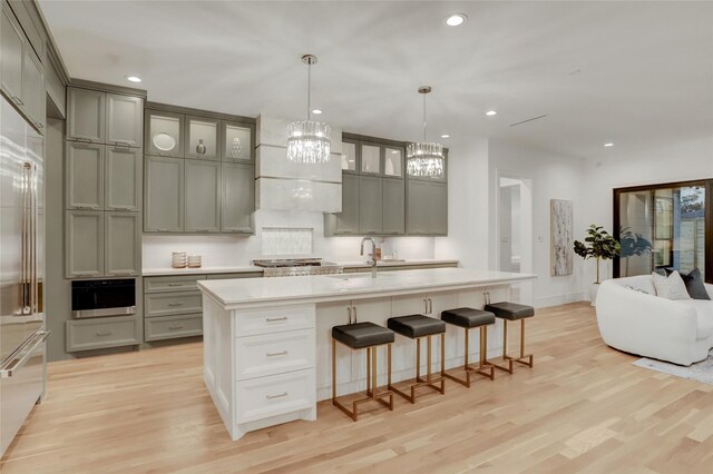 962 Lamonte Ln, Houston, TX 77018 - kitchen featuring gray cabinets, a chandelier, light wood-style floors, and recessed lighting