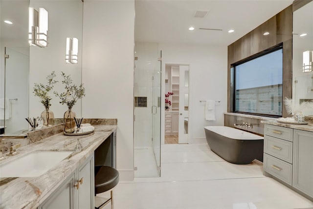 962 Lamonte Ln, Houston, TX 77018 - full bathroom with a stall shower, a freestanding bath, vanity, a spacious closet, and tile patterned flooring