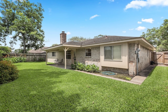 3009 Stacy Ln, Deer Park, TX 77536 - rear view of house featuring a chimney, brick siding, a patio area, and a fenced backyard